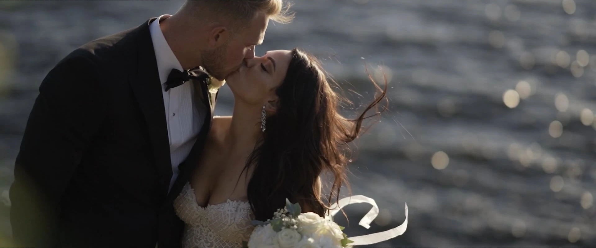 Nicole and Elias kissing by the water at Ekensdal, Stockholm